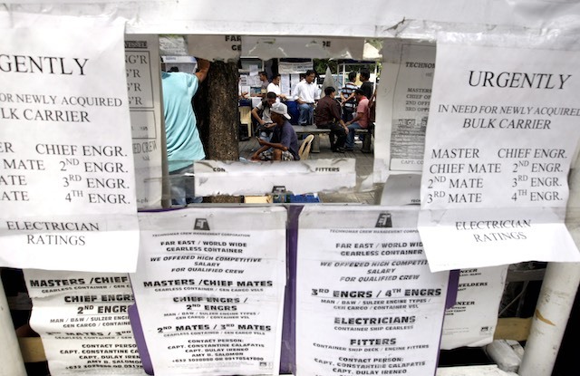 , Filipino job seekers who want to work abroad view job opportunities ...