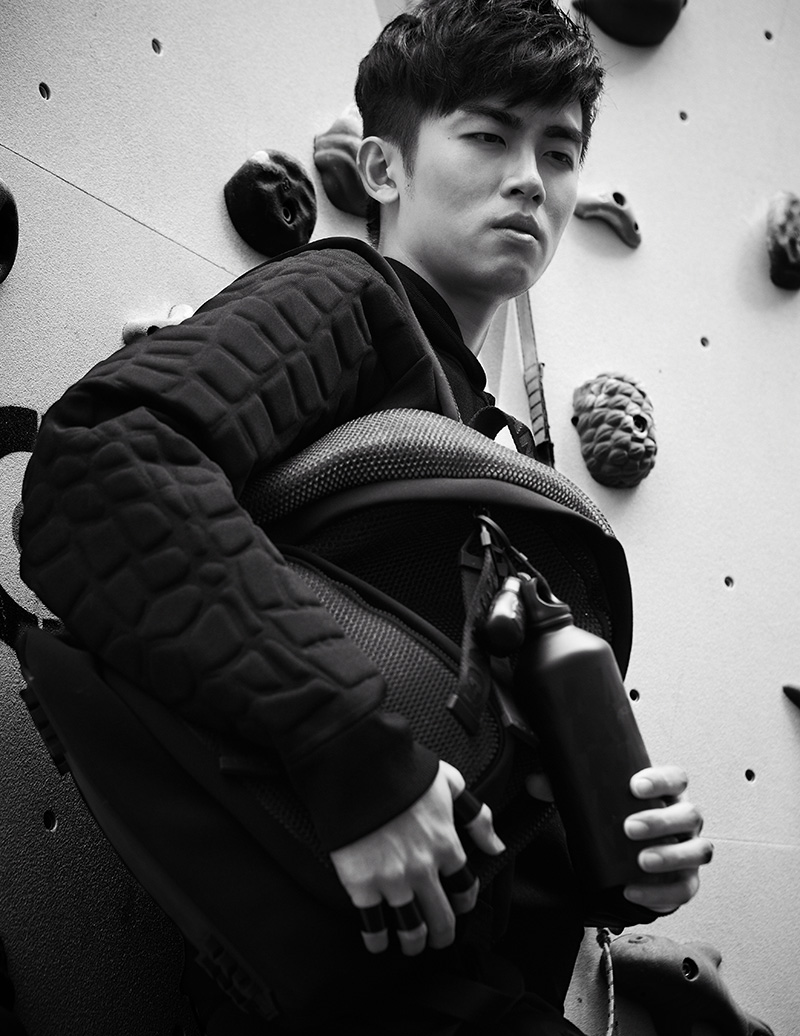Junjie L. wears: Hoodie with croco-patterned sleeves, with mesh backpack, boxing gloves, key ring, and metal water bottle