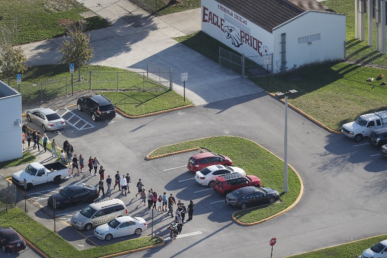 EVACUATION. People are brought out of the Marjory Stoneman Douglas High School after a shooting at the school that reportedly killed and injured multiple people on February 14, 2018 in Parkland, Florida. Joe Raedle/Getty Images/AFP 