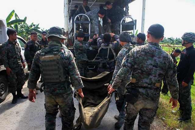 SAF 44. SAF troopers carry the remains of their fallen comrades. File photo by Mark Navales/AFP 