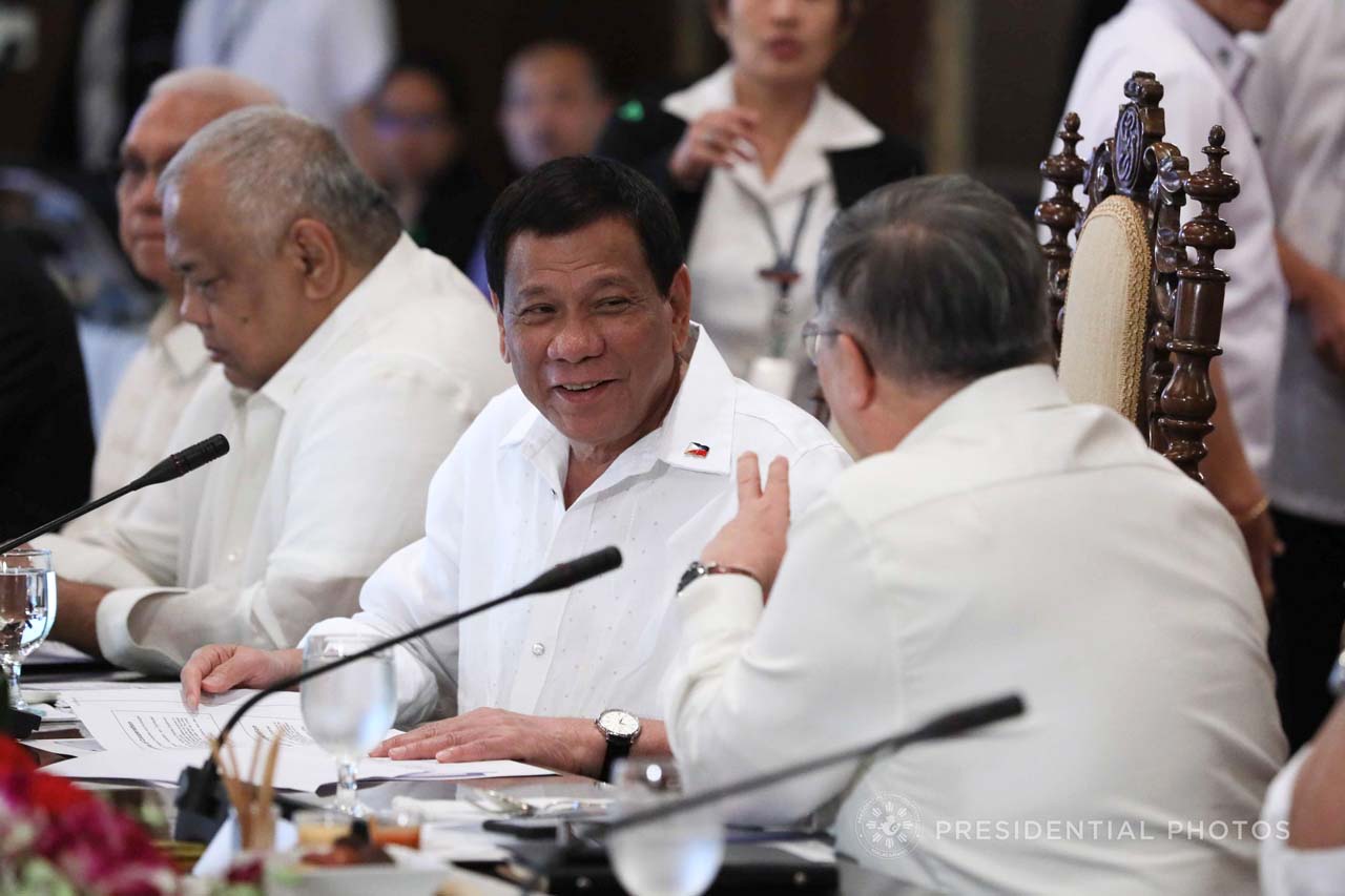 TAX REFORM GREENLIGHTED. President Rodrigo Duterte shares a light moment with Finance Secretary Carlos Dominguez III during the cabinet cluster meeting in Malacañang. Malacañang file photo 