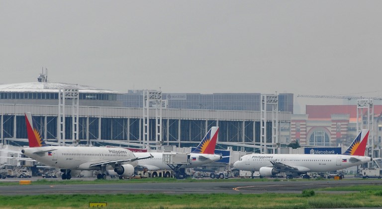 Planes are parked at the tarmac of the Ninoy Aquino International Airport (NAIA) in Manila on August 5, 2010. Noel Celis/AFP 