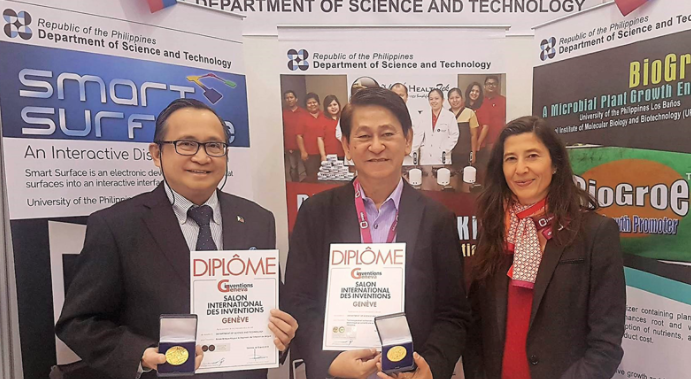 PH REPS. Director Edgar Garcia (right) and Ivan Garcia, Philippine permanent representative to the United Nations Office in Geneva, hold the plaques for gold medal winners Smart Surface and Biotek-M at the 2018 Geneva Inventions competition in Switzerland. Photo from DOST-TAPI  