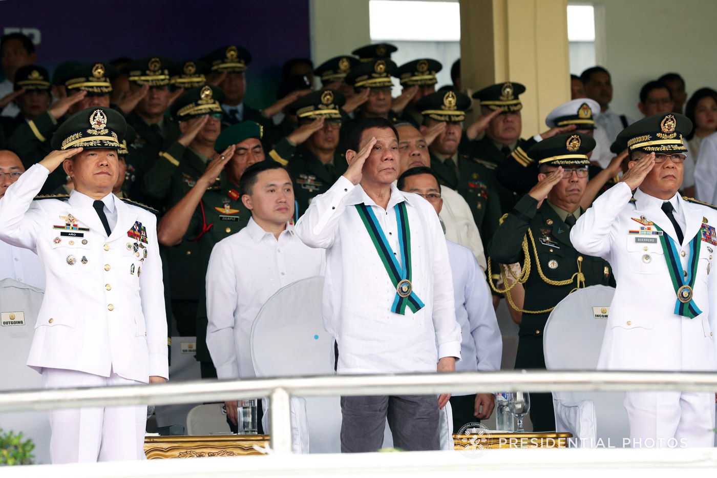 CHANGE OF COMMAND. President Rodrigo Duterte (center), retired General Eduardo Año (left), and new AFP chief Lieutenant General Rey Guerrero (right) salute the troops during the AFP change of command ceremony at Camp Aguinaldo on October 26, 2017. Malacañang photo     