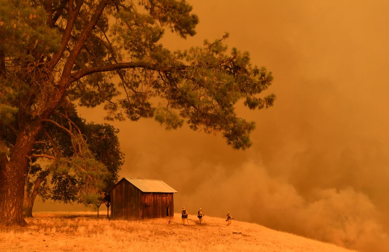 WILDFIRE. Firefighters watch as flames from the County Fire climb a hillside in Guinda, California, on July 1, 2018.  Photo by Josh Edelson/AFP  