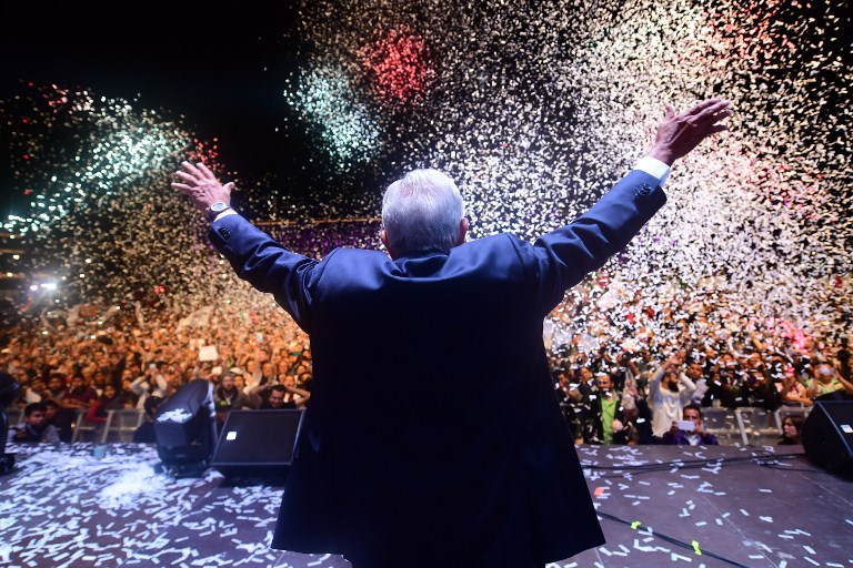 POLL WINNER. Newly elected Mexico's President Andres Manuel Lopez Obrador of the 'Juntos haremos historia' party, cheers his supporters at the Zocalo Square in Mexico City on July 1, 2018, after winning general elections. Photo by Pedro Pardo/AFP   