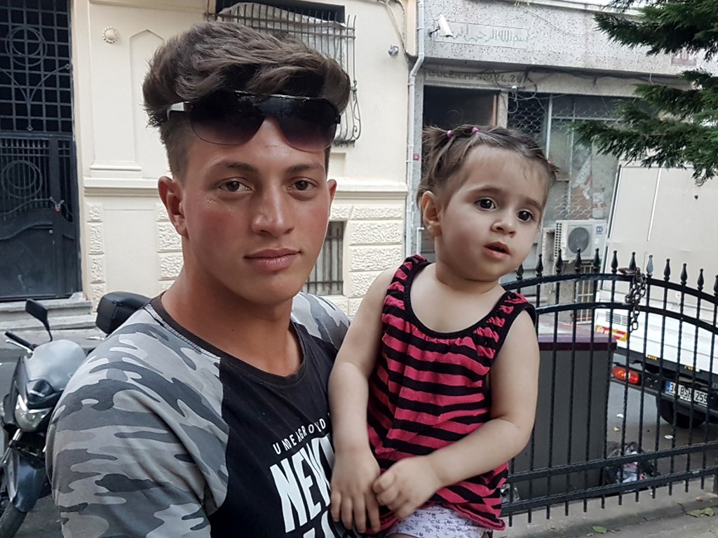 LUCKY. Algerian citizen Fawzi Zabaat (L), 17, poses with Syrian toddler Doha Muhammed he caught as she was falling from the second floor at Fatih district in Istanbul on June 27, 2019. Photo by STR/DHA/AFP 