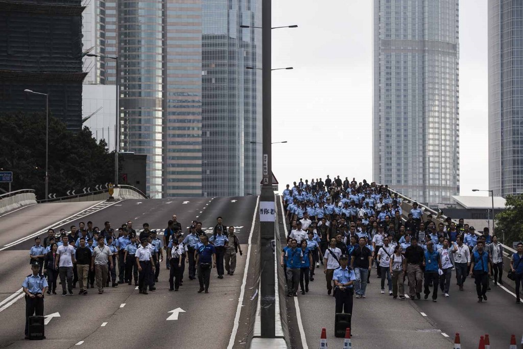HONG KONG PROTESTS. Police arrive to negotiate with protesters to clear a road in Hong Kong early on June 17, 2019. Photo by Isaac Lawrence/AFP  