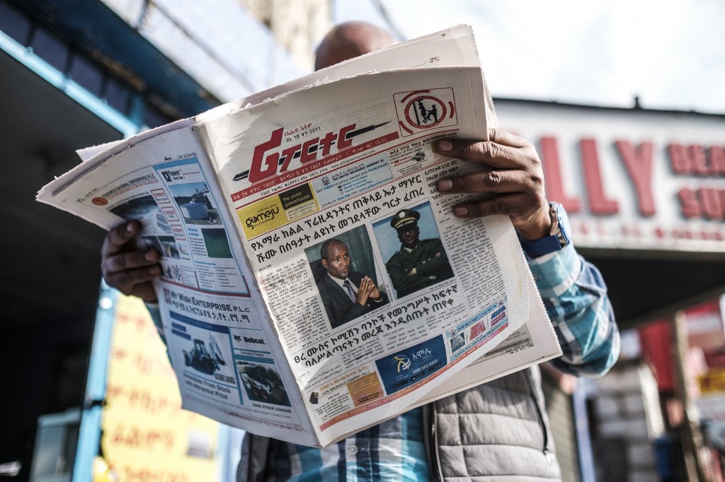 NEWS. A man reads the Ethiopian newspaper 'The Reporter', depicting the portraits of killed Ambachew Mekonen (L), President of the Ahmara Region, and of Gen. Seare Mekonnen, Chief of Staff of the Ethiopian National Forces, in Addis Ababa, on June 24, 2019. Photo by Eduardo Soteras/AFP  