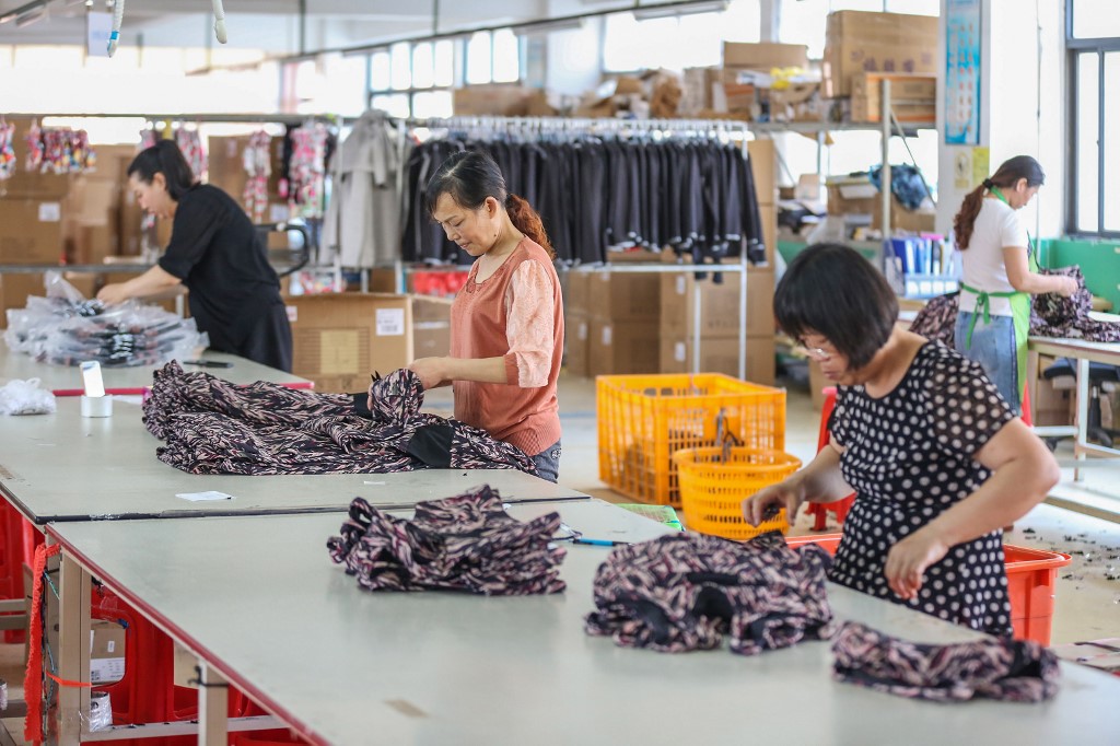CHINESE ECONOMY. This picture taken on May 14, 2019, shows workers making clothes for export at a factory in Quanzhou in China's eastern Fujian province. File photo by AFP 