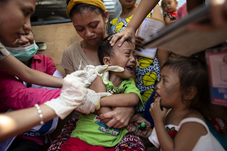 OUCH. A child reacts during a Philippine Red Cross Measles Outbreak Vaccination Response at the Baseco compound in Tondo, Manila on February 16, 2019. Photo by Noel Celis/AFP 