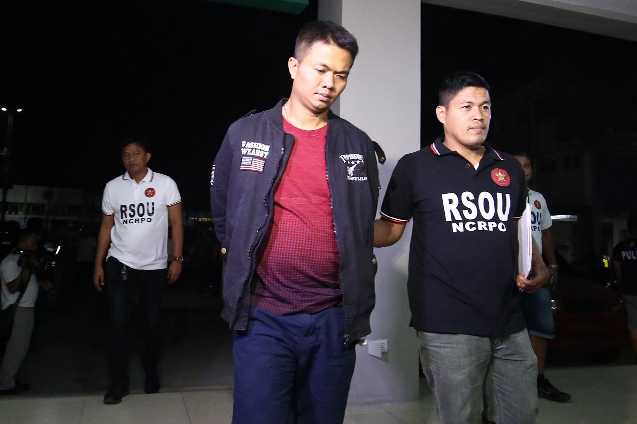 ARRESTED. Newbie cop Marlo Quibete is brought in by a member of the Regional Special Operations Unit-National Capital Region Police Office, on March 6, 2019, following his arrest.  
Photo by Ben Nabong/Rappler   