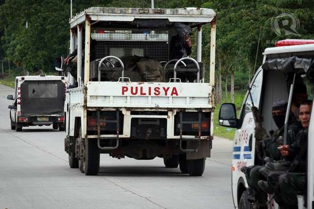 A police truck carrying the bodies of comrades passes the national highway during a retrieval operation on January 26, 2015 in Mamasapano, Maguindanao Province.   