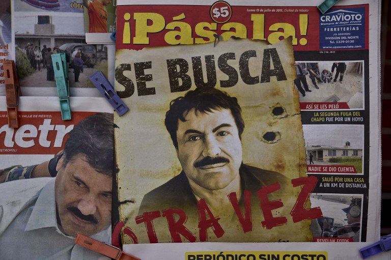 A poster with the face of Mexican drug lord Joaquin "El Chapo" Guzman, reading "Wanted, Again", is displayed at a newsstand in one Mexico City's major bus terminals on July 13, 2015. He has since been captured. AFP PHOTO / YURI CORTEZ 