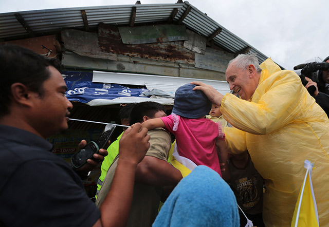 POPE IN A RAINCOAT. Pope Francis visits families of typhoon Yolanda victims in one of the areas in Palo, Leyte Saturday, January 17, 2015. Photo by Benhur Arcayan/Malacanang Photo Bureau