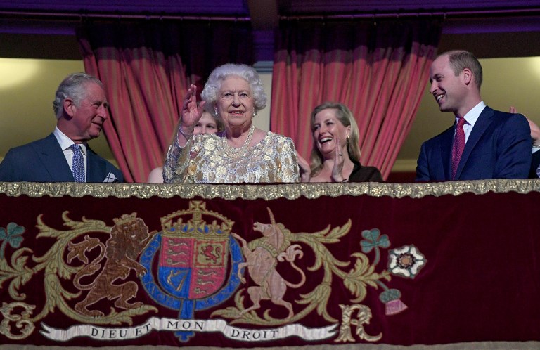 92ND BIRTHDAY. Britain's Queen Elizabeth II (center L) waves to guests as her son Britain's Prince Charles, Prince of Wales (L) and grandson Britain's Prince William, Duke of Cambridge (R) react as she takes her seat ni the Royal box during The Queen's Birthday Party concert at the Royal Albert Hall in London on April 21, 2018. Photo by Andrew Parsons/AFP  