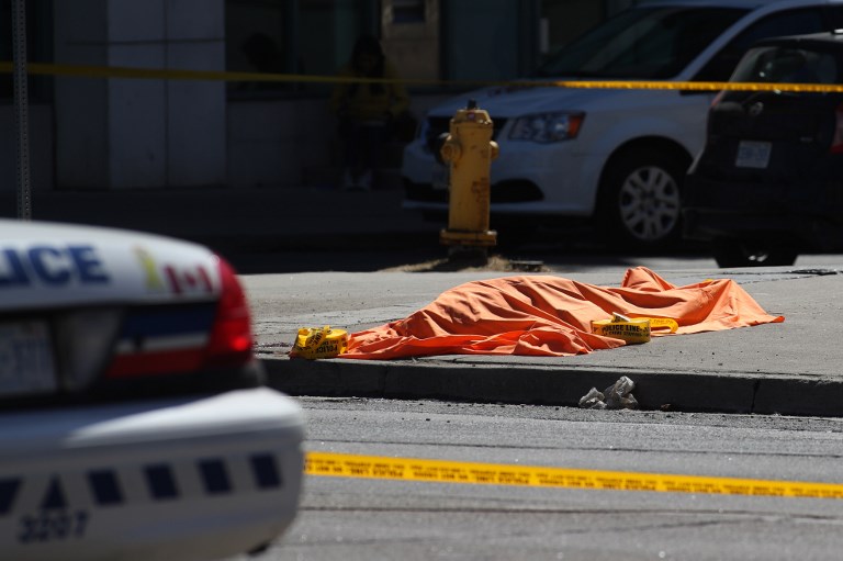 VAN ATTACK. An unidentified body is seen near the crime scene after a truck hit several pedestrians in Toronto, Ontario, on on April 23, 2018. Photo by Lars Hagberg/AFP  