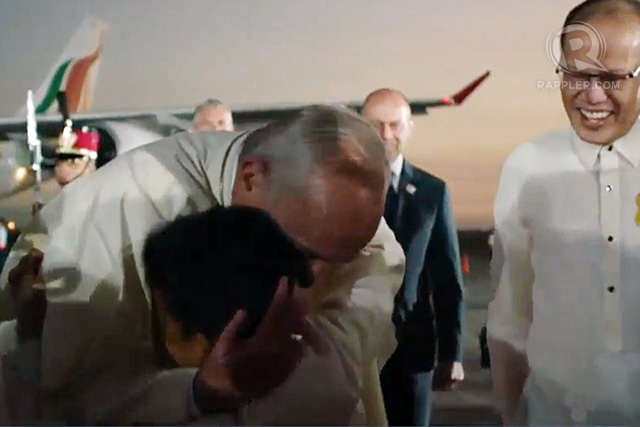 Pope Francis hugs Mark Angelo Balbero, 10, who welcomed him at the arrival ceremony at the Villamor Airbase in Pasay City, January 15, 2015. Philippine President Benigno Aquino III looks on. Rappler photo