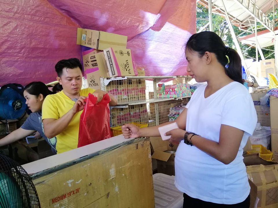 PROJECT FOR QUAKE VICTIMS. A woman displaced by the recent earthquakes in Mindanao buys her needs at the MinDA-organized Tienda outlet in Bansalan, Davao del Sur on November 15, 2019. Photo from the Mindanao Development Authority 