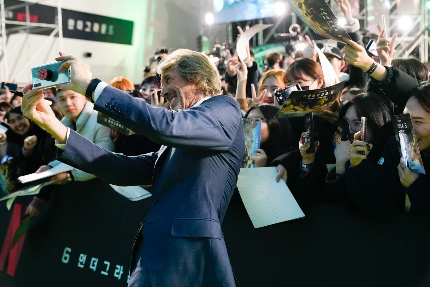Lucky fans: 6 Underground director Michael Bay holds up the phone for a selfie with fans at the world premiere of his Netflix movie at Dongdaemun Design Plaza on December 02, 2019 in Seoul, South Korea. Photo courtesy of Netflix 