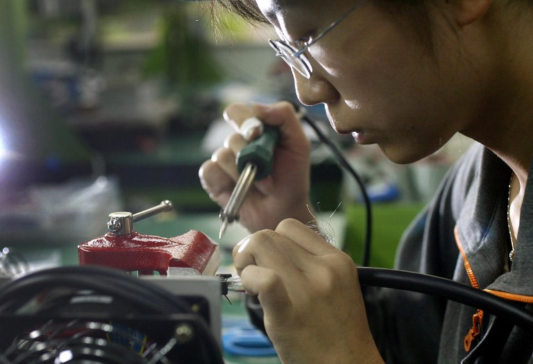 MORE OPPORTUNITIES. ASEAN integration is expected to bring more investments to the manufacturing sector. But the country needs to amend restrictive legislation to see the full benefits, says NEDA chief Arsenio Balisacan. File photo by Frederic J. Brown/Agence France-Presse