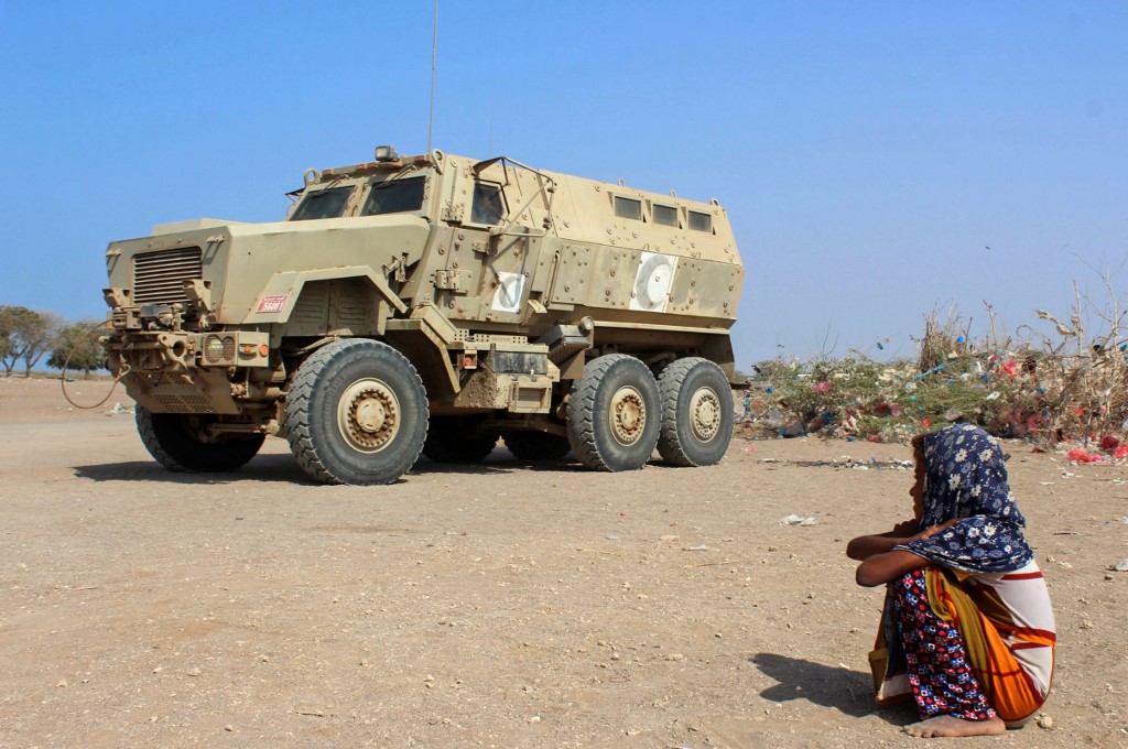 WAITING. A displaced Yemeni girl sits next to an armoured military vehicle at a camp in the Khokha district of the western province of Hodeida, on January 21, 2019. Photo by Saleh Al-Obeidi/AFP 