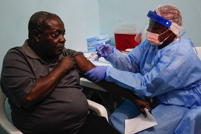 ONGOING CARE. A Liberian nurse administers an experimental Ebola vaccine at the beginning of a trial program at the Redemption Hospital in New Kru Town, outside Monrovia, Liberia, February 2, 2015. File photo by Ahmed Jallanzo/EPA 