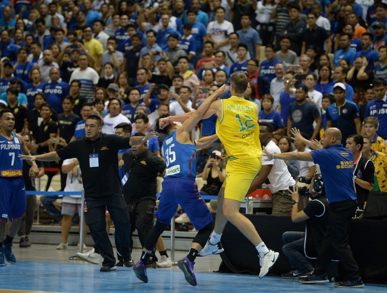 BASKETBRAWL. Gilas Pilipinas player Mathew Wright (left)  and Australia's Daniel Kickert engage in a fistfight during the two teams' brawl-marred FIBA match. Photo by Ted Aljibe/AFP  
