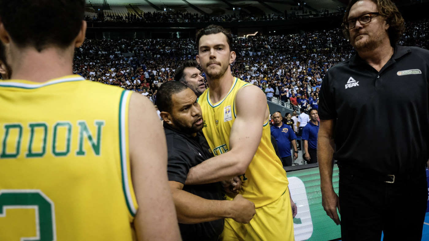 RESTRAINED. The Australian team management actively restrained Angus Brandt and the rest of the Aussie players from clearing the bench. Photo by Josh Albelda/Rappler  