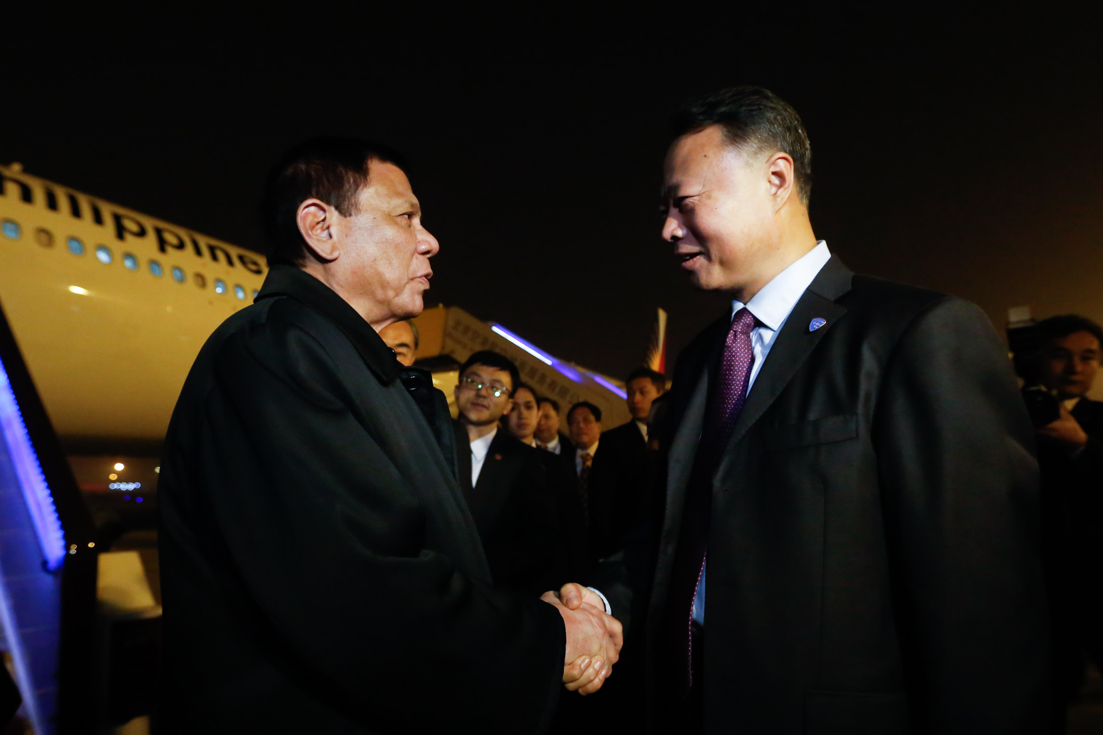 TIES WITH CHINA. President Rodrigo Duterte is greeted by Chinese Ambassador to the Philippines Zhiao Jianhua upon his arrival at the Beijing Capital International Airport on October 17, 2016. Photo by Toto Lozano/Presidential Photo 