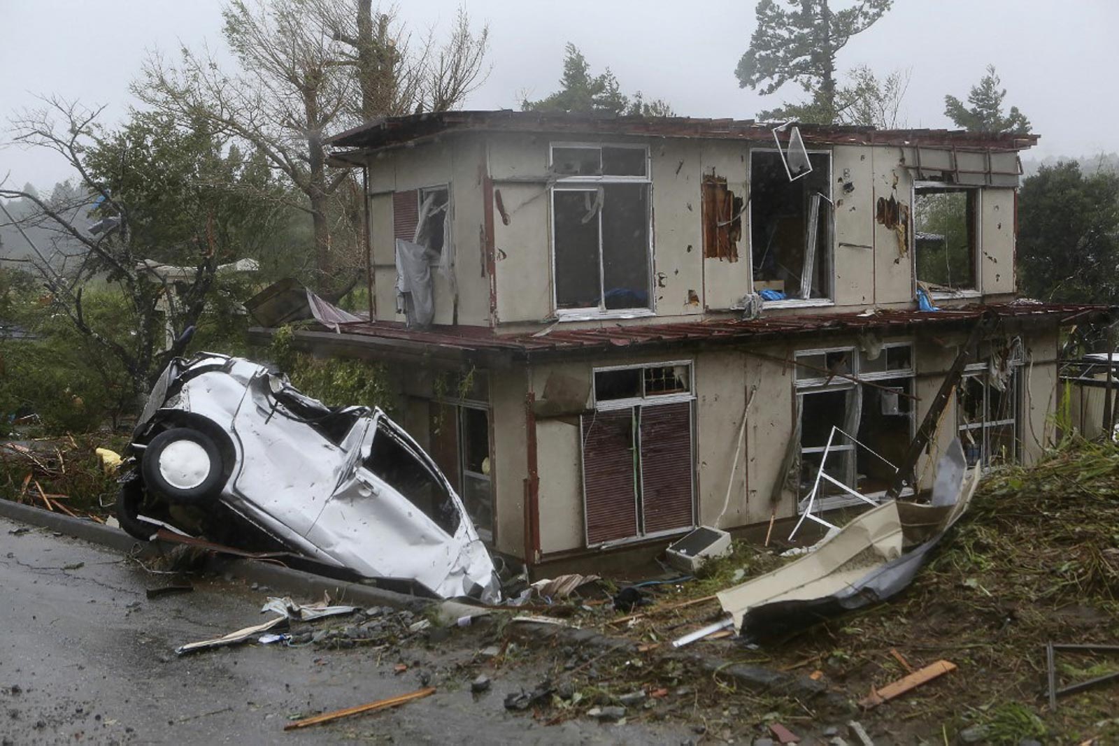 TYPHOON HAGIBIS. A damaged vehicle sits in a ditch next to a badly damaged house after strong winds brought by Typhoon Hagibis hit the area in Ichihara, Chiba prefecture on October 12, 2019. Photo by Jiji Press/AFP 