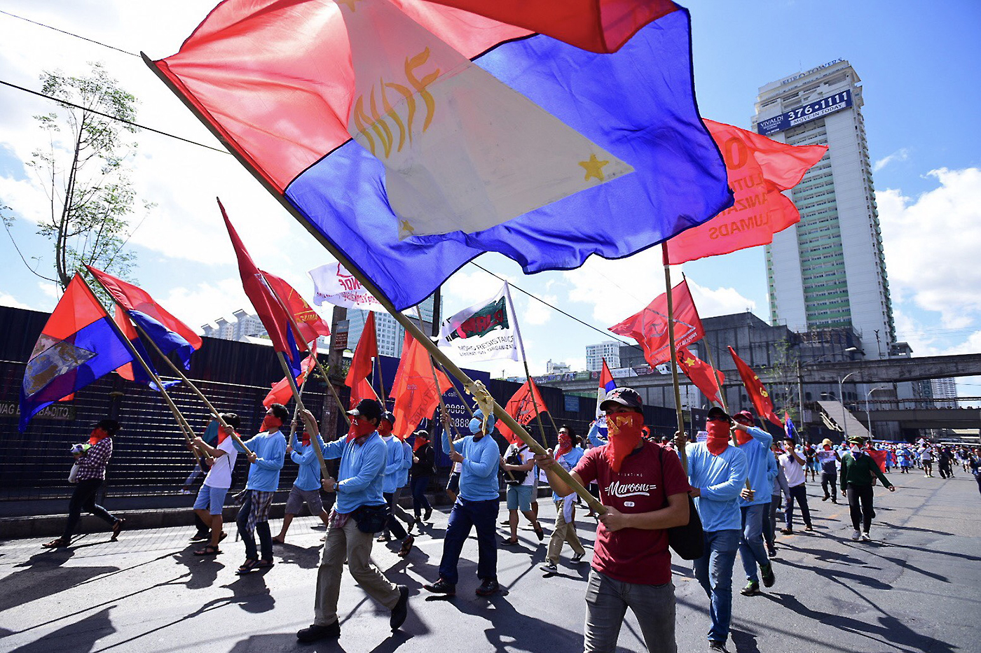 LIGHTNING RALLY. Supporters of the National Democratic Front Philippines march along Aurora Blvd. in Cubao, Quezon City on April 23, 2018, to mark the 45th anniversary of the revolutionary front. All photos by Maria Tan, DarrenLangit/Rappler 