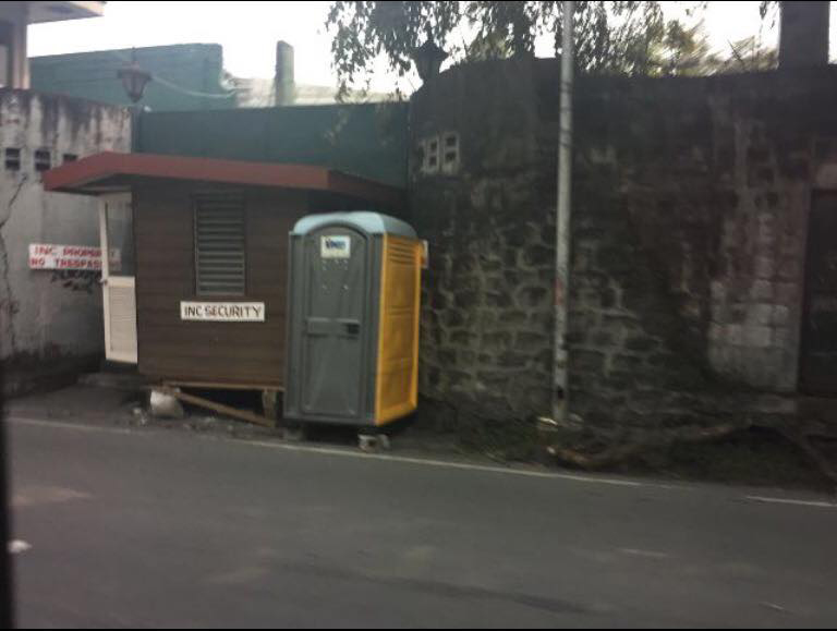 BLOCKED. A portable toilet and a guardhouse block the gate of the Manalo residence in Quezon City.   