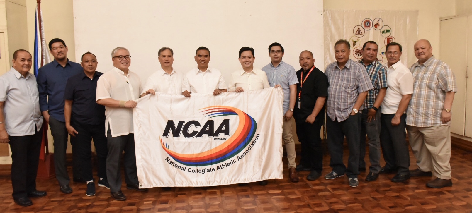 NEW HOST. Perpetual Help president Anthony Tamayo (7th from right) receives the league flag from Fr. Nemesio Tolentin, OAR (6th from left) of San Sebastian and other officials during the formal turnover rites of the NCAA hosting. Photo by Dennis Abrina  