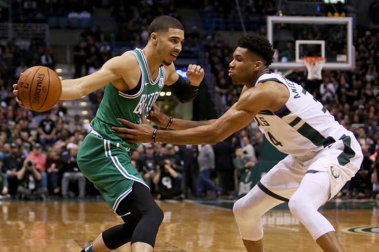 ALL EVEN. Boston's Jayson Tatum tries to shake off Milwaukee's Giannis Antetokounmpo. Photo by Dylan Buell/Getty Images/AFP 
