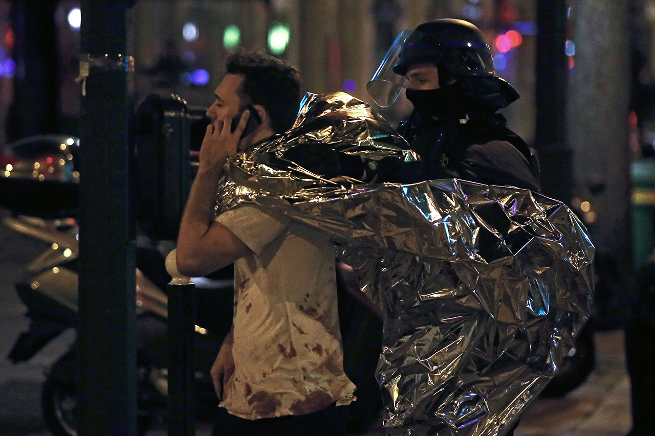 INJURED. A man with blood on his shirt talks on the phone next to the Bataclan where a shooting and a hostage situation took place earlier tonight in Paris, France, 14 November 2015. Photo by Etienne Laurent/EPA 