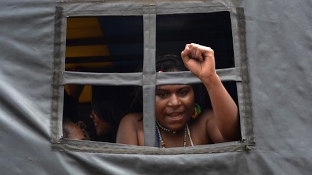 PROTEST. An arrested Papuan pro-independence demonstrator gestures from a police truck in Jakarta on December 1, 2015, after police fired tear gas at a hundreds-strong crowd hurling rocks during a protest against Indonesian rule over the eastern region of Papua. File photo by AFP 