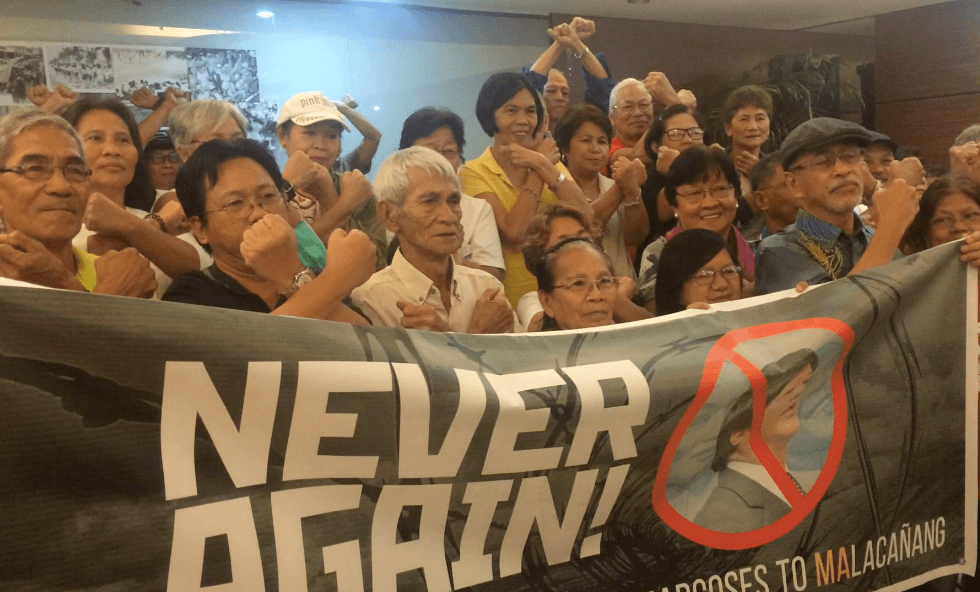 NEVER AGAIN. Martial Law victims oppose the 'return of the Marcoses' in the Palace. Photo by Patty Pasion / Rappler 