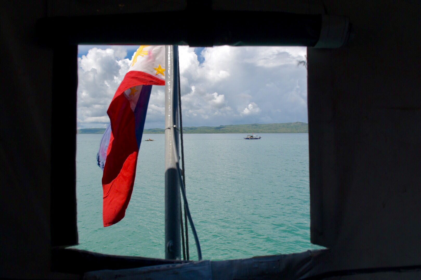 PHILIPPINE WATERS. A Philippine flag is flown in a boat off the waters near the coast of Occidental Mindoro in the West Philippine Sea. File photo by LeAnne Jazul/Rappler  