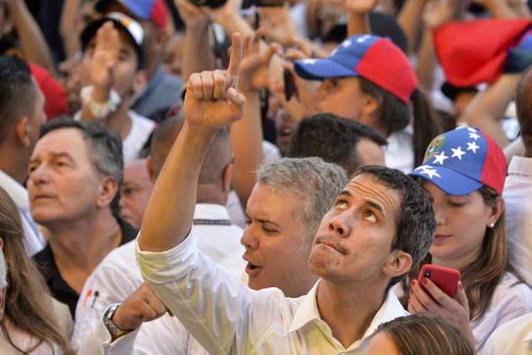 DEFIANT. Venezuela's opposition leader Juan Guaido gestures during the 'Venezuela Aid Live' concert, organized to raise money for the Venezuelan relief effort, at the head of the Tienditas International Bridge in Cucuta, Colombia, on February 22, 2019. Photo by Luis Robayo/AFP 