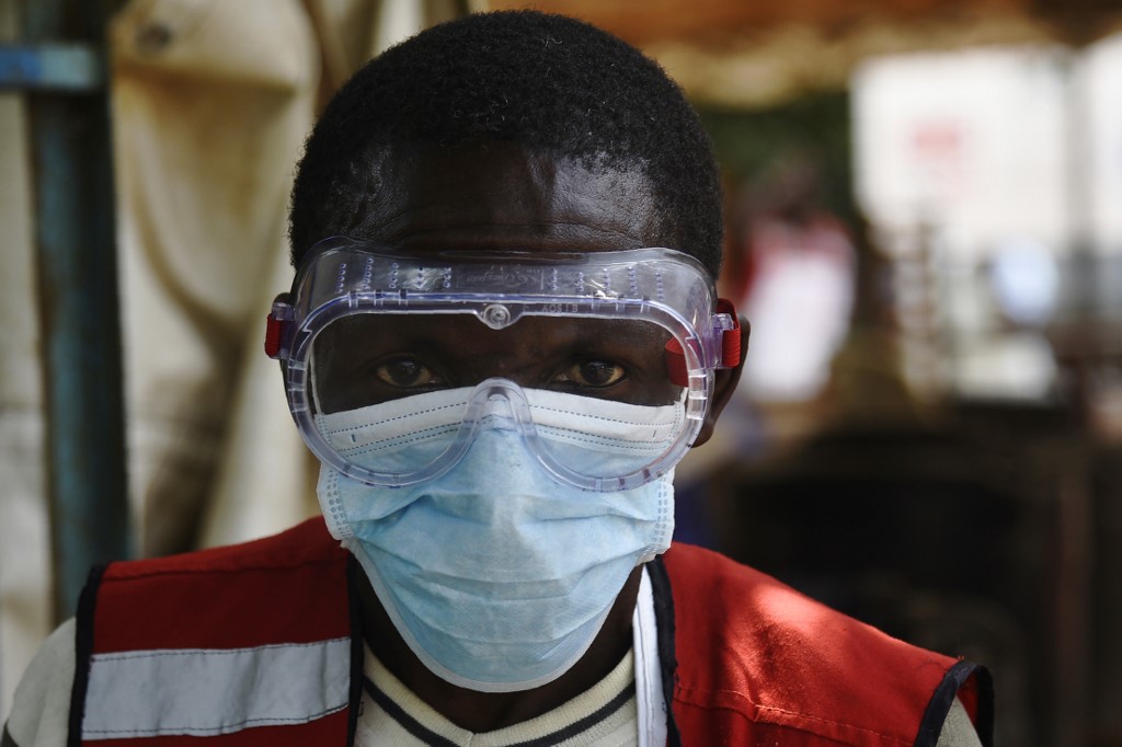FRONTLINE. A health worker wears protective gears at the Mpondwe Health Screening Facility in the Uganda border town with the Democratic Republic of Congo, on June 13, 2019. Photo by Isaac Kasamani/AFP  
