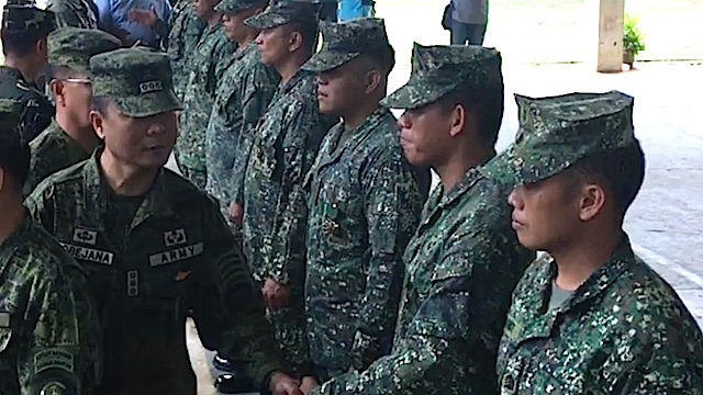 MILITARY MERIT MEDALS. Joint Task Force Sulu commander Brigadier General Cirilito Sobejana congratulates his men for successful operations versus the Abu Sayyaf 
