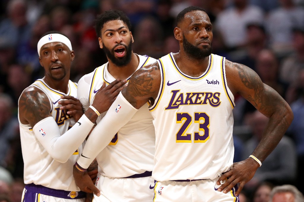 RESTRAINT. Anthony Davis of the Los Angeles Lakers is restrained by Kentavious Caldwell-Pope and Lebron James after being called for a foul against the Denver Nuggets in the third quarter at Pepsi Center on December 03, 2019 in Denver, Colorado. 
Photo by Matthew Stockman/Getty Images/AFP 