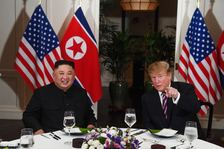 FRIENDS. US President Donald Trump speaks with North Korea's leader Kim Jong-un as they sit for a dinner at the Sofitel Legend Metropole hotel in Hanoi on February 27, 2019. Photo by Saul Loeb/AFP  