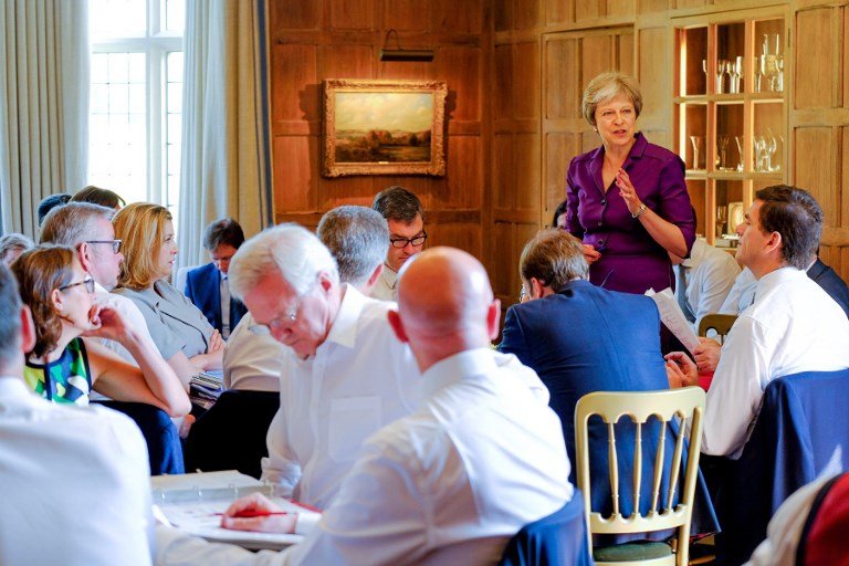 CABINET MEETING. In this handout image taken and released on July 6, 2018, by the Prime Minister's Press Office, Britain's Prime Minister Theresa May speaks to members of her cabinet at the Prime Minister's rural country residence, Chequers, west of London. Photo by Crown Copyright (Joel Rouse)/AFP 