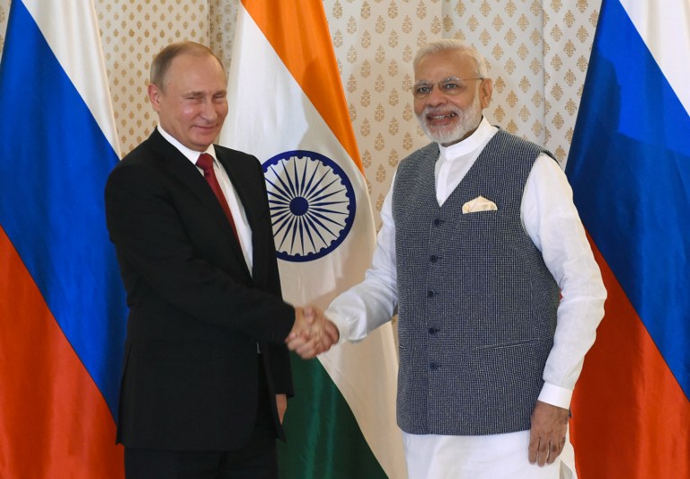 PUTIN IN INDIA. Indian Prime Minister Narendra Modi (R) shakes hands with Russian President Vladimir Putin ahead of the Indo-Russia Annual Summit at Taj Exotica Hotel in Goa on October 15, 2016. Prakash Singh/AFP 