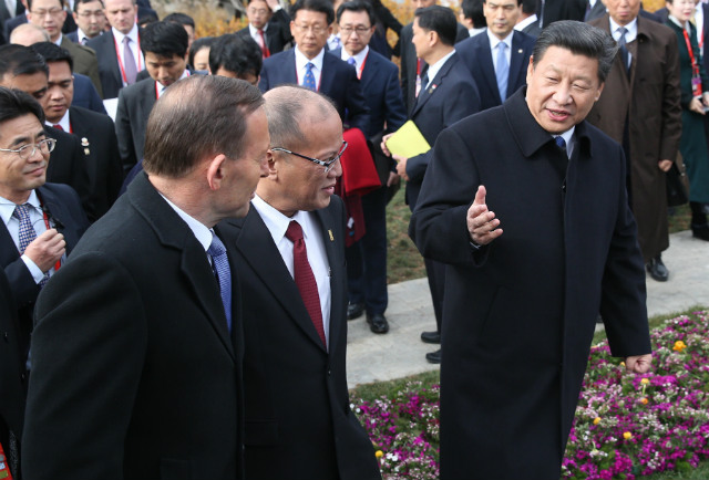 FRIENDLY EXCHANGES. Philippine President Benigno Aquino III (left) chat with Chinese President Xi Jinping (right) during a tree-planting ceremony as part of the 22nd Asia-Pacific Economic Cooperation Leaders' Meeting in China in November 2014. Photo from www.gov.ph 