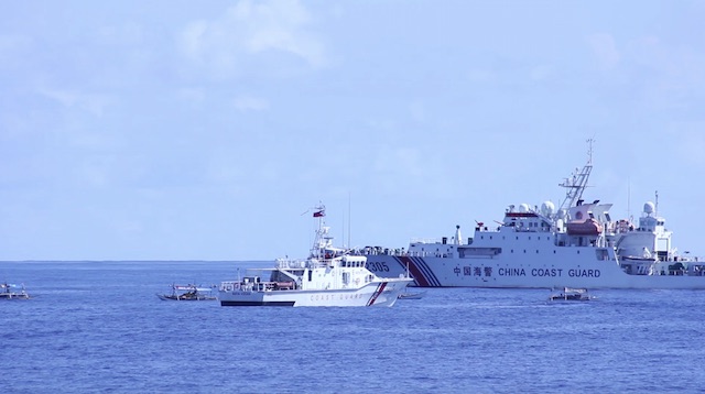 DANGEROUS MANEUVER. A Chinese Coast Guard ship blocks Philippine ship BRP Nueva Vizcaya and small Filipino fishermen's boats 