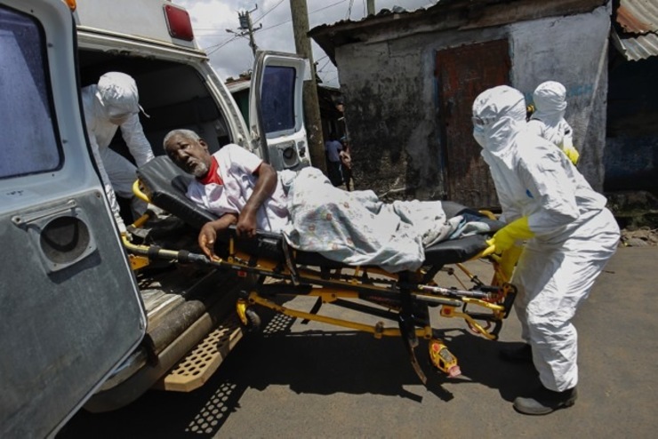 GLOBAL CALLS FOR HELP. A Liberian ambulance team transport the 70-year old Francis Konneh, a suspected Ebola patient from the township of West point in Monrovia, Liberia, 15 October 2014. Photo by Ahmed Jallanzo/EPA