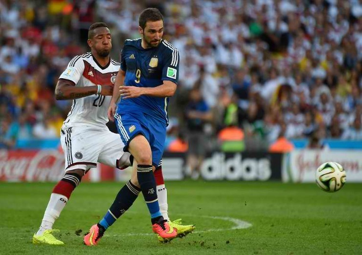 Germany's defender Jerome Boateng vies with Argentina's forward Gonzalo Higuain in the first half of the World Cup final. Higuain came so close to scoring for La Albiceleste twice in the match. Photo by Odd Andersen/AFP